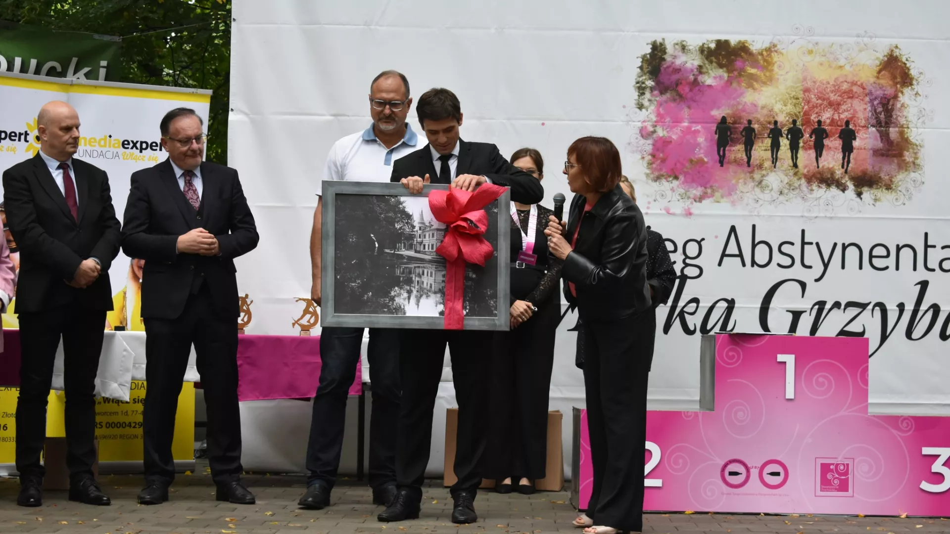 Sekretarz Agnieszka Kotynia przekazuje na ręce dyrektora Konrada Grzyba pamiątkową reprodukcję fotografii dawnego pałacu Potockich.