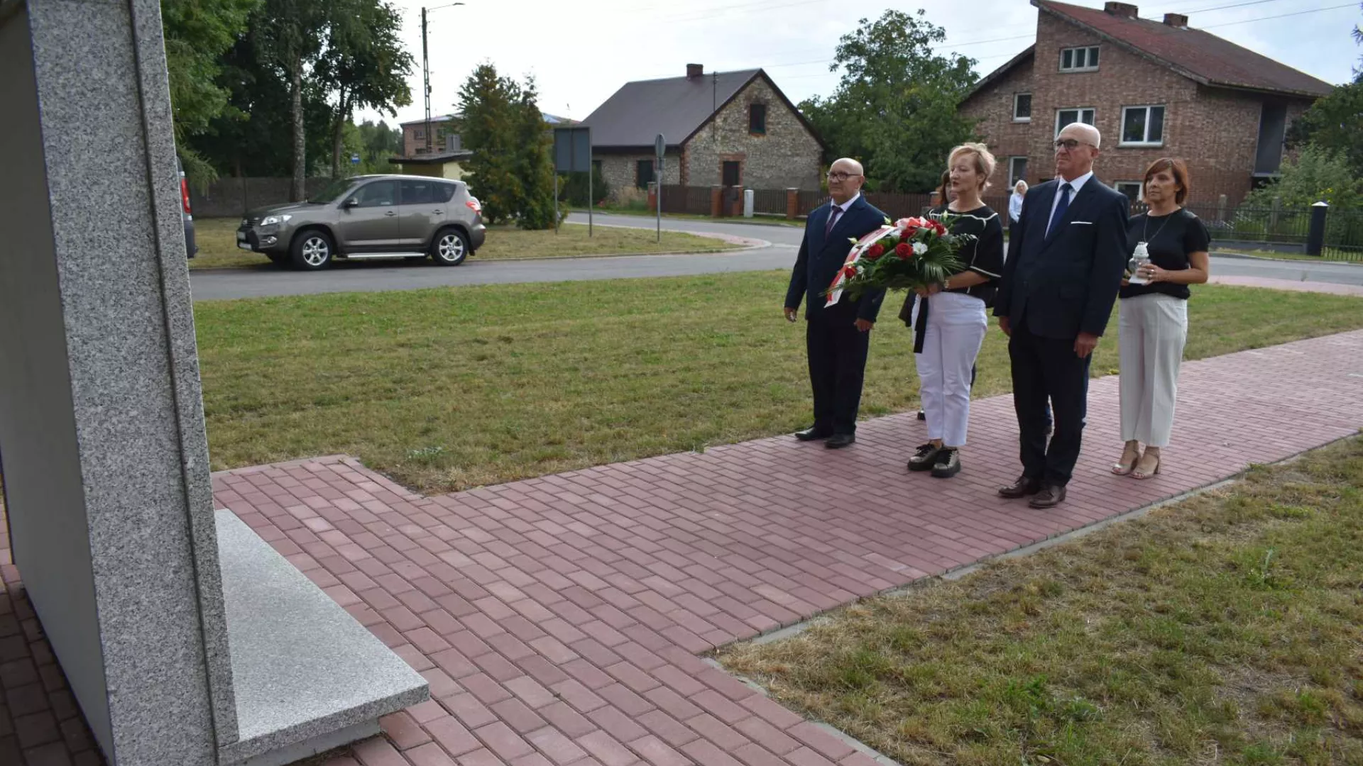 Złożenie kwiatów pod tablicą upamiętniającą ofiary wojny z Zimnowody.