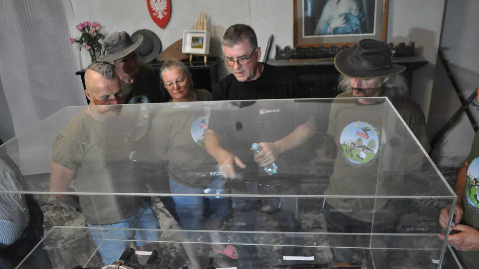 Uczestnicy Wakacji z Historią oglądają wystawę replik broni w dworku w Lipiu.