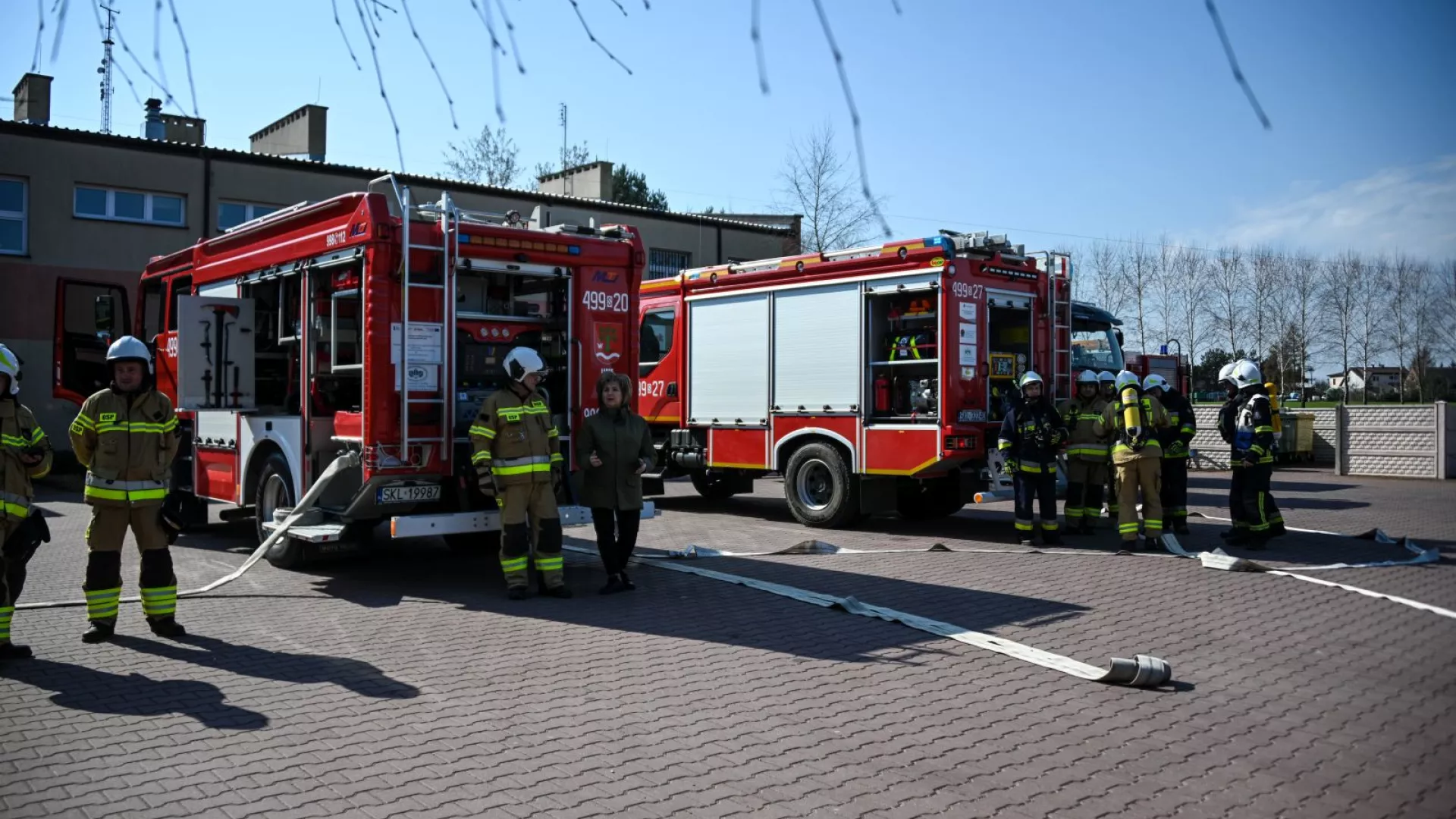 Wójt Gminy Lipie i strażacy na tle samochodów strażackich podczas ćwiczeń w ZS-P Lipie