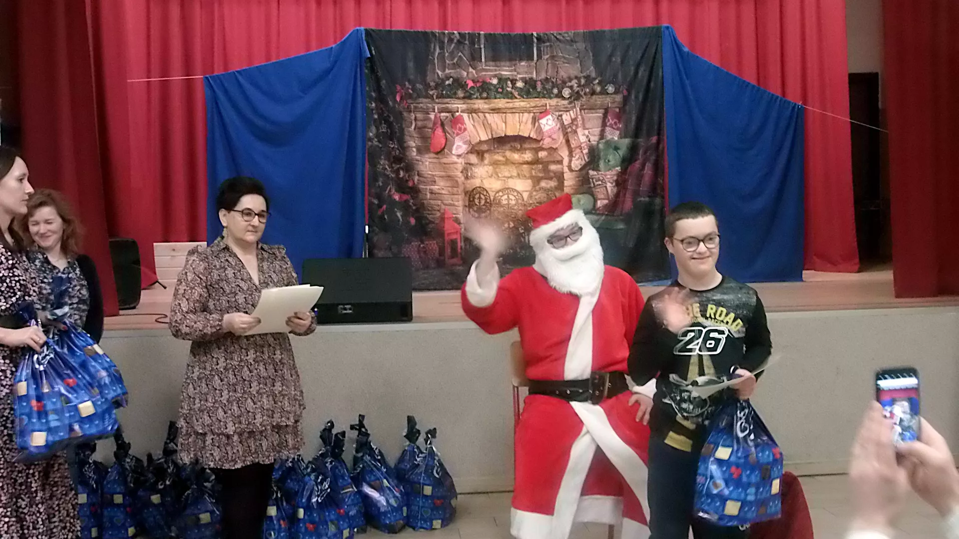 Mikołaj rozdaje prezenty.