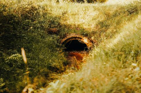 Zaniedbany przepust pod zjazdem z drogi.